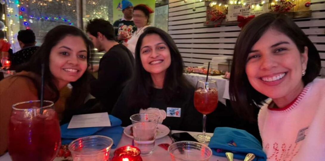 Three women dining together at a reception event